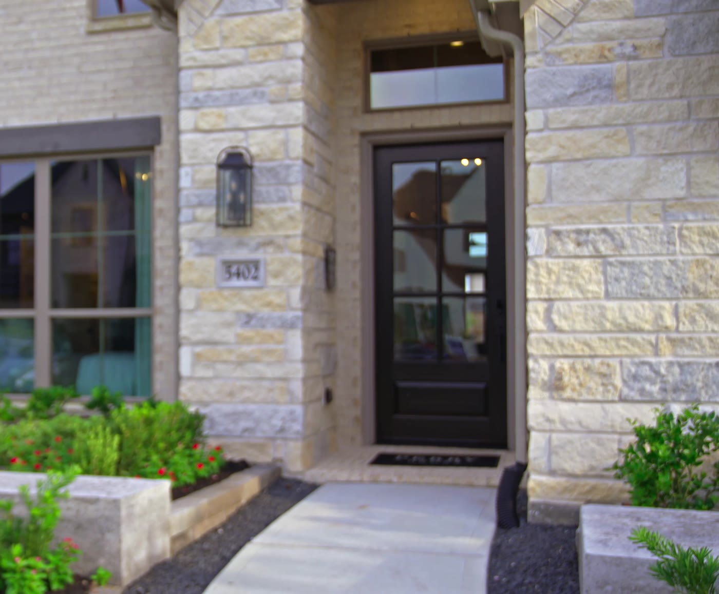 Stone-front entry with a dark iron door